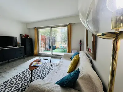 a living room with a couch and a table at Appartement avec grande terrasse in Nice