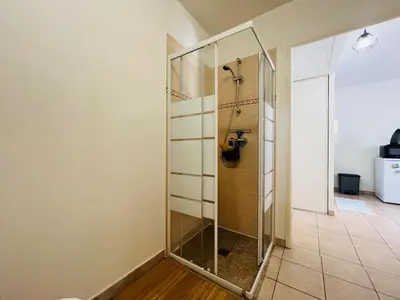 a bathroom with a shower with a glass partition at Coeur de Nice in Nice
