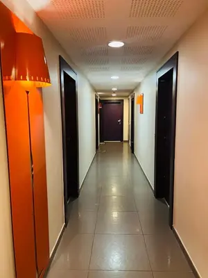 a corridor of a hallway with doors and a long hallway at Coeur de Nice in Nice