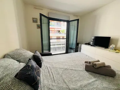 a bedroom with a bed with a teddy bear on it at Coeur de Nice in Nice
