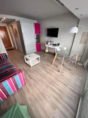 a living room with a couch and a table at Studio at the heart of Carre D'or 2 mins Sea Wi-fi in Nice