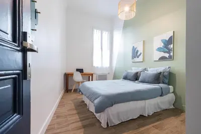a bedroom with a bed and a desk in it at Noa house in Nice