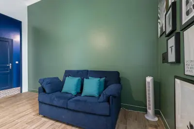 a blue couch with two blue pillows in a living room at Noa house in Nice