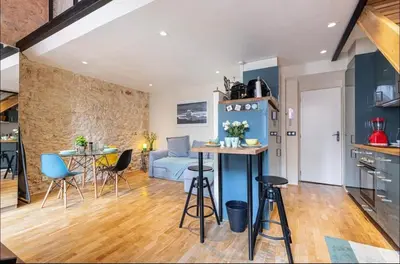 a kitchen and living room with a table and chairs at Duplex center of Nice with AC in Nice