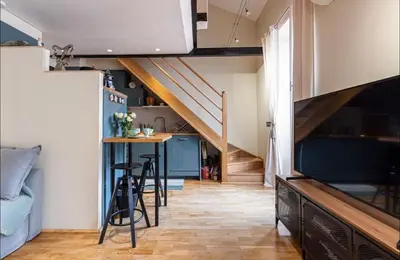 a loft conversion with a staircase and a table in a room at Duplex center of Nice with AC in Nice