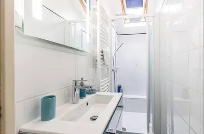 a white bathroom with a sink and a shower at Duplex center of Nice with AC in Nice