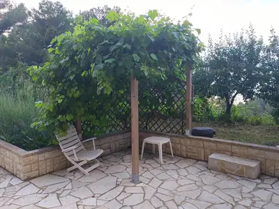 a chair and umbrella under a tree on a patio at Grand Chalet at Villa Don Quijote Nice in Nice