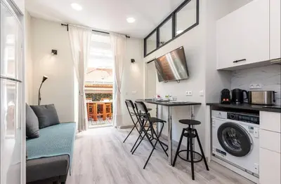 a kitchen with a table and chairs in a room at 1 bed, center of Nice with AC in Nice