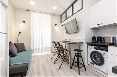 a kitchen and living room with a table and chairs at 1 bed, center of Nice with AC in Nice