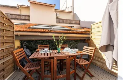 a wooden table and chairs on a patio at 1 bed, center of Nice with AC in Nice