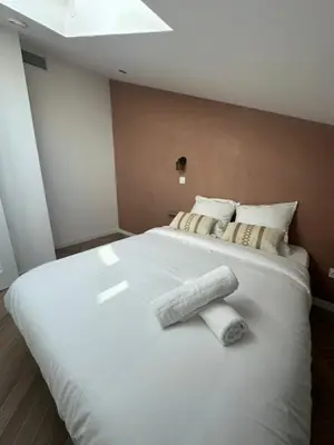 a large white bed with two towels on it at GIOFFREDO SUITE in Nice