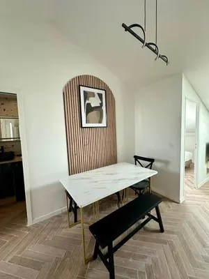 a dining room with a table and a chair at GIOFFREDO SUITE in Nice