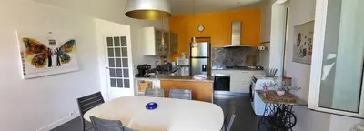 a kitchen with a white table in a room at Vacation location in Tourrette-Levens