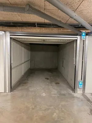 an empty parking garage with a large door at Nice modern flat in Nice