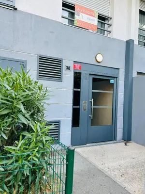 a building with a blue door with a light on it at Nice modern flat in Nice