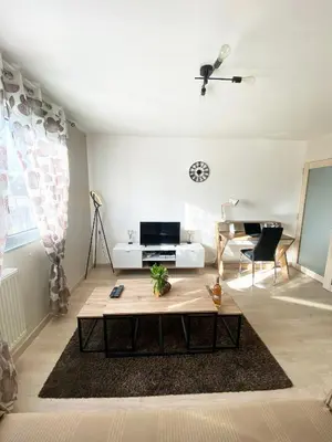 a living room with a coffee table and a couch at Bel Appartement 2 pièces - 10min de la mer in Nice