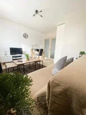 a living room with a bed and a tv at Bel Appartement 2 pièces - 10min de la mer in Nice