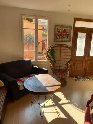 a living room with a couch and a table at Maison de ville avec jardin in Nice