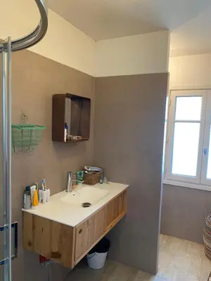 a bathroom with a white sink and a window at Maison de ville avec jardin in Nice