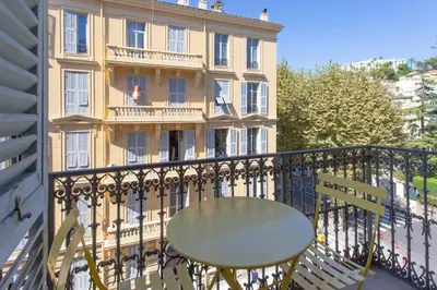 a balcony with a table and a building at GIOA- Studio avec balcon, place Garibaldi -Paillon in Nice