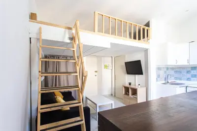 a small room with a bunk bed and a kitchen at GIOA- Studio avec balcon, place Garibaldi -Paillon in Nice