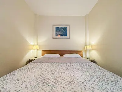 a bedroom with a large bed with two lamps at Cozy 3 pièces, centre historique - Wifi, AC, 5pers in Nice