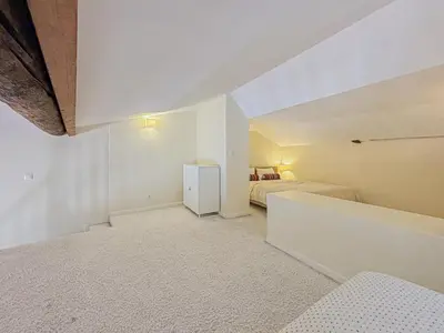 a white room with a bed and a refrigerator at Cozy 3 pièces, centre historique - Wifi, AC, 5pers in Nice
