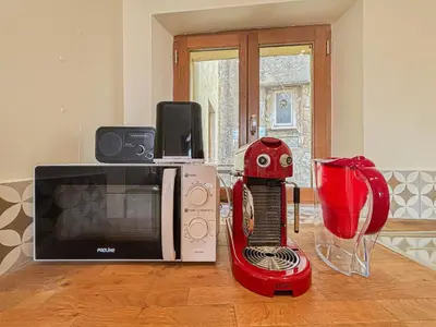 a kitchen with a microwave and a red blender at Cozy 3 pièces, centre historique - Wifi, AC, 5pers in Nice