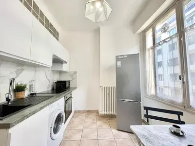 a kitchen with a refrigerator and a washer and dryer at Belle Nuit in Nice