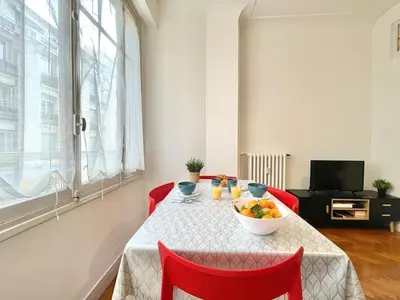 a dining room table with a bowl of fruit on it at Belle Nuit in Nice