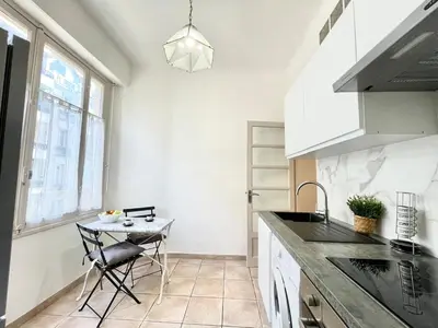 a kitchen with a small table and a sink at Belle Nuit in Nice