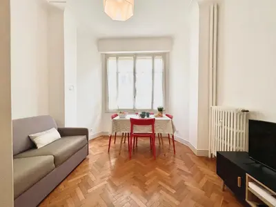 a living room with a couch and a table at Belle Nuit in Nice