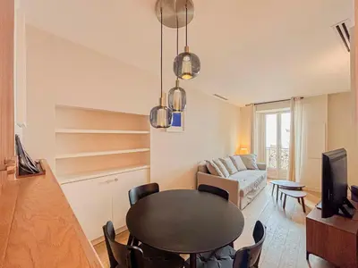 a living room with a table and a couch at Petit cocon au cœur du Vieux-Nice, Wifi, AC, 2pers in Nice