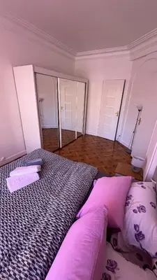 a bedroom with a large bed with purple pillows at LE REX Nice in Nice