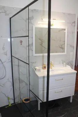 a bathroom with a white sink and a mirror at LE REX Nice in Nice