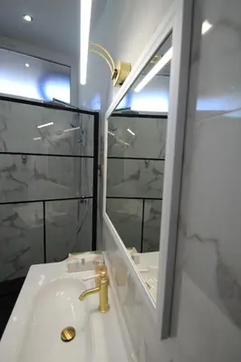 a bathroom with a sink and a mirror at LE REX Nice in Nice