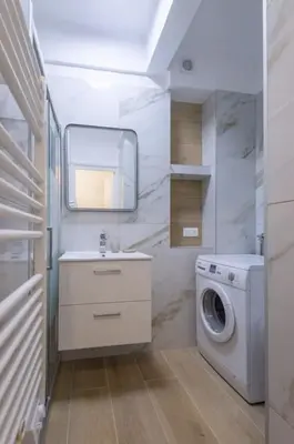 a kitchen with a table and a table and a window at Charmant studio rue Hérold - Wifi, AC, 2pers in Nice