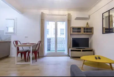 a living room with a couch and a table at Charmant studio rue Hérold - Wifi, AC, 2pers in Nice