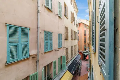 an alley with green shutters on a building at Chic & Cozy 2 Bdr Heart of the Old Town in Nice