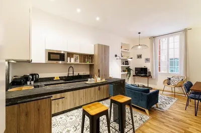 a kitchen and living room with a blue couch at Chic & Cozy 2 Bdr Heart of the Old Town in Nice