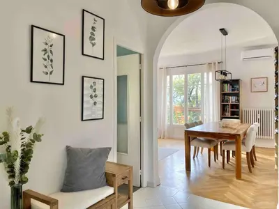 a living room with a table and a dining room at Nice Sea View 2 bedroom apartment in Nice