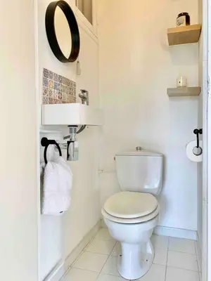 a bathroom with a white toilet and a sink at Nice Sea View 2 bedroom apartment in Nice