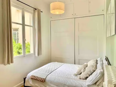 a bedroom with a bed and a window at Nice Sea View 2 bedroom apartment in Nice