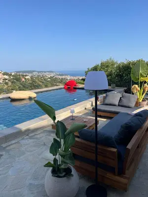 a patio with a pool with a couch and a lamp at Villa location saisonniere in Nice