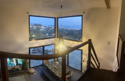 a room with a staircase with large windows at Villa location saisonniere in Nice