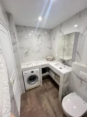 a white bathroom with a sink and a washing machine at Appart T2 refait à neuf 50m2 in Nice