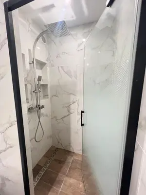 a shower with a glass door in a bathroom at Appart T2 refait à neuf 50m2 in Nice