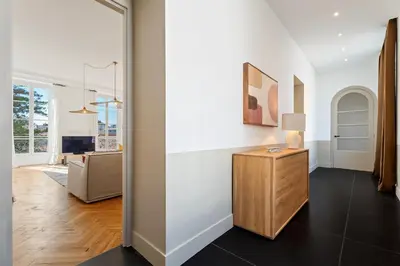 a living room with white walls and a wooden table at Nice Renting - VICTOR - Historic Palace Luxury 3 Bedrooms in Nice