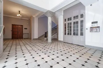 an empty hallway with a staircase and a pillar at Nice Renting - VICTOR - Historic Palace Luxury 3 Bedrooms in Nice