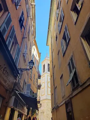 a tall building with a clock tower in the distance at Carré d'Or - Studio lumineux à 5 minutes de la plage in Nice